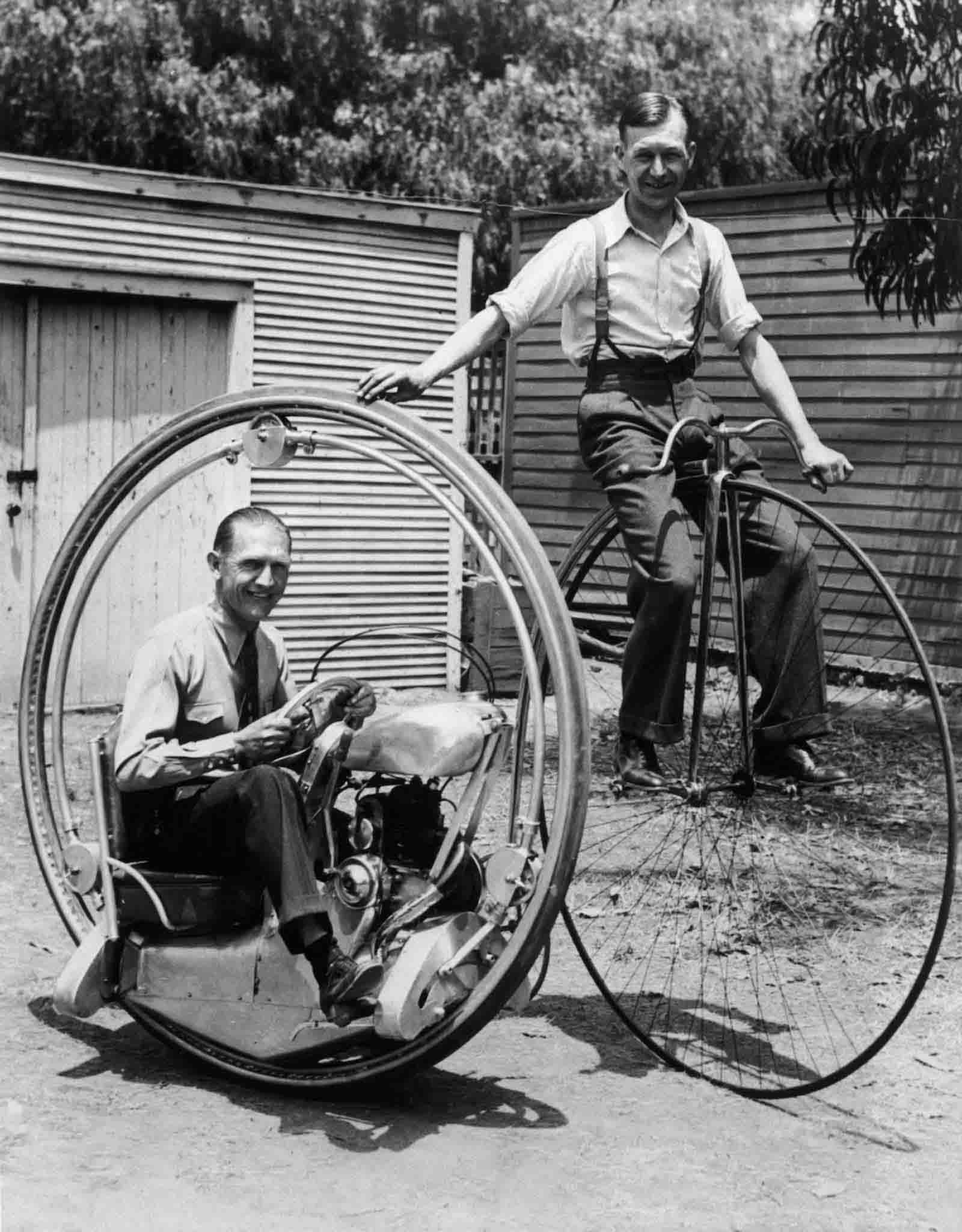 A man on a penny-farthing bicycle alongside Walter Nilsson aboard the Nilsson monowheel, 1935.