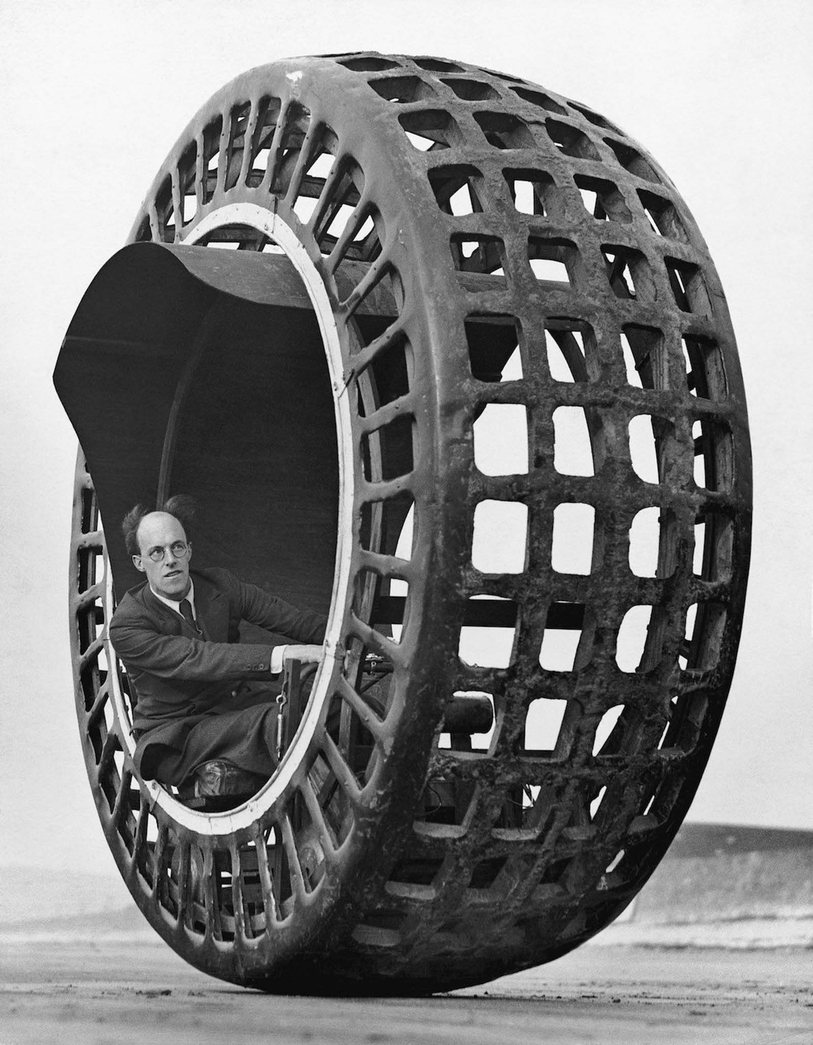 J. A. Purves drives a Dynasphere spherical car, an automobile shaped like a giant radial tire. Mr. Purves was the vehicle’s inventor, 1932.
