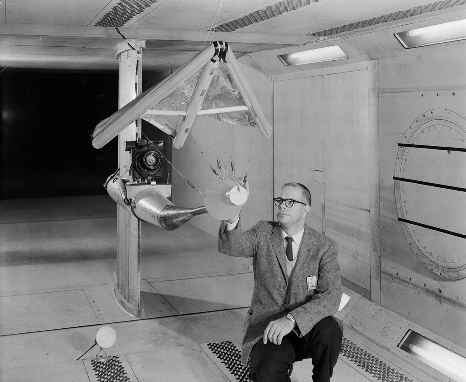 W. C. Sleeman, Jr. inspects a model of a paraglider in the 300 mph, 7 x 10-foot Wind Tunnel.