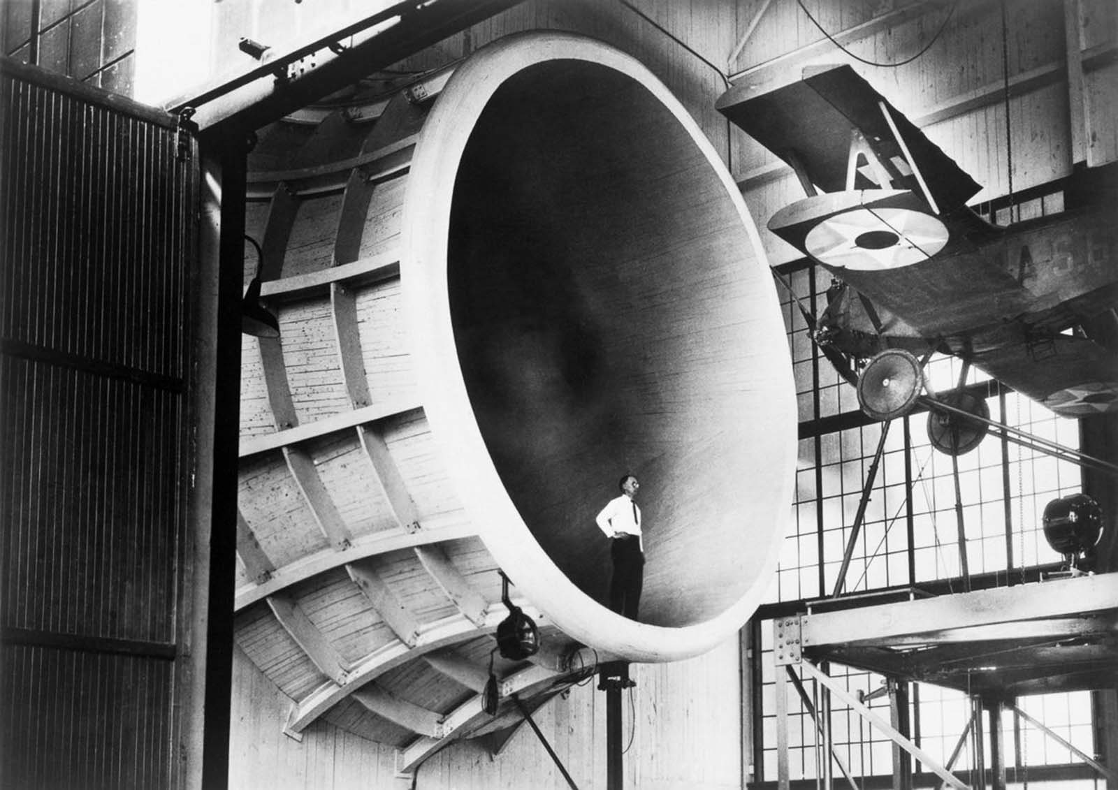 A Langley researcher observes a Sperry M-1 Messenger, the first full-scale airplane tested in the Propeller Research Tunnel, 1927.