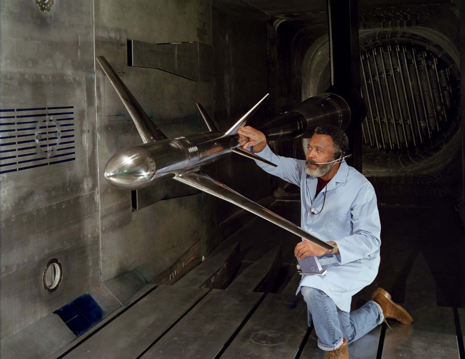 NASA technician W.L. Jones inspects a transport model Pathfinder I between test runs at Langley’s National Transonic Facility, 1986.