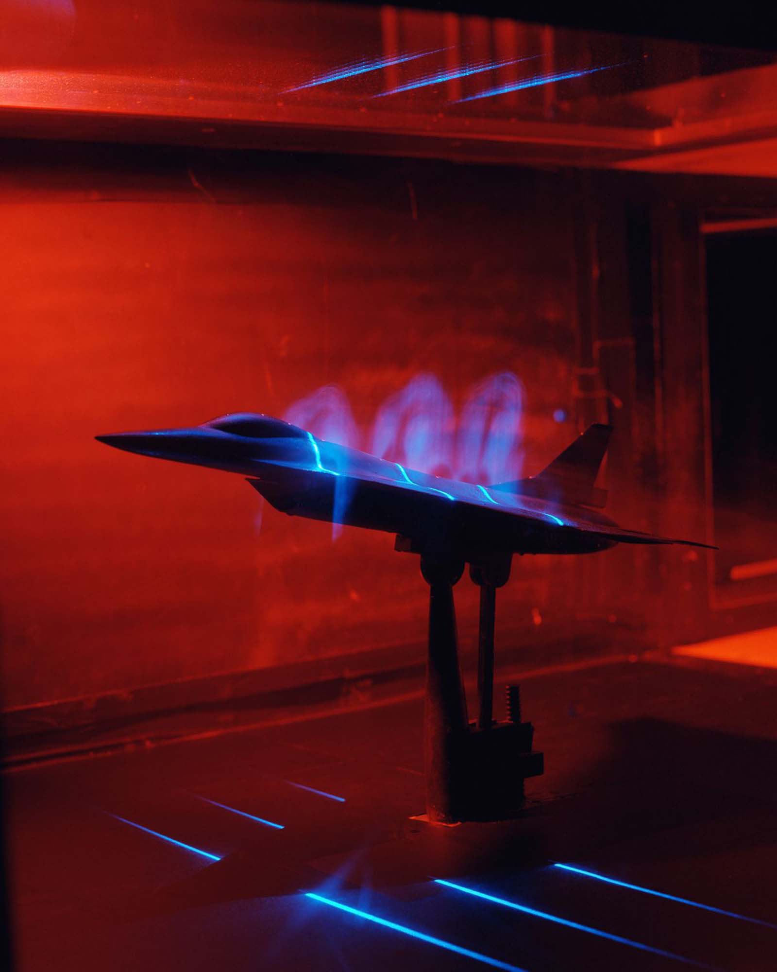 An F-16 model in a flow visualization test using smoke and a laser light sheet to illuminate the smoke, 1992.