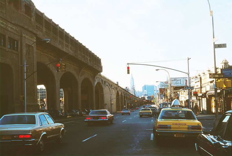 Queens Boulevard at 40th Street, #7 subway viaduct at the left, Empire State Building in the distance