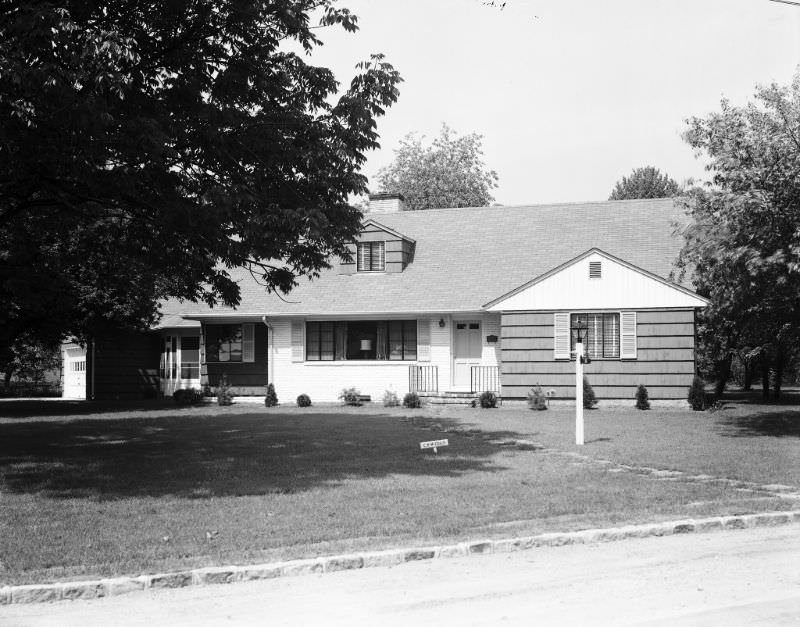 238 (street unidentified), 1947. C.K. McCully on sign near lamppost