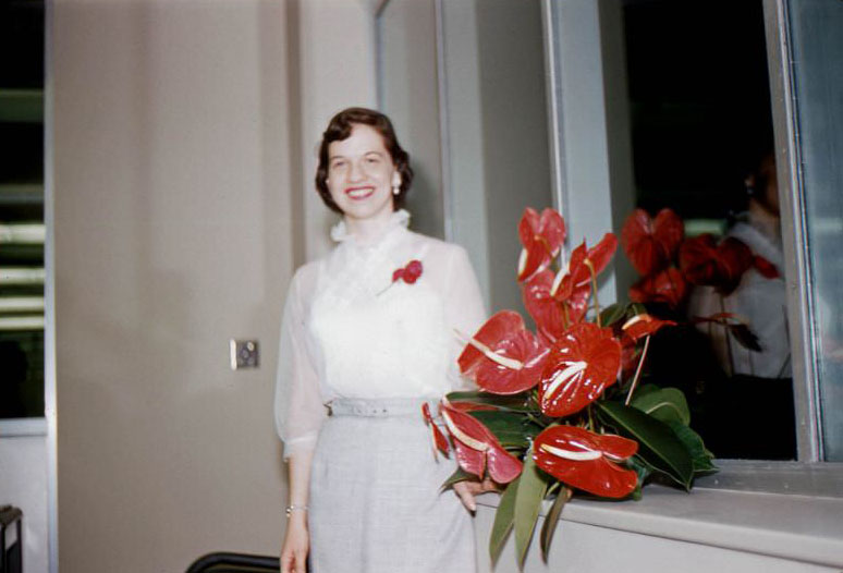 Pat Sullivan and anthurium in the new building of the DuPage Division, Chicago Title & Trust, Wheaton, Illinois, 1954