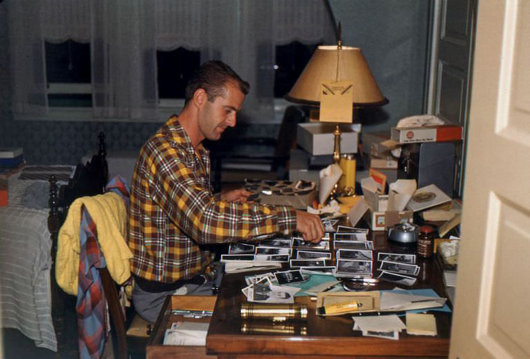 Robert Kross (1920-2011) with his photo prints and negatives at Elmhurst, Illinois, 1952