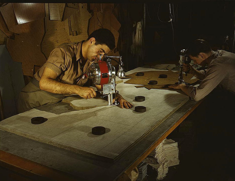 The utmost precision is required of these operators who are cutting and drilling parachute packs in an eastern factory, Manchester, 1950s