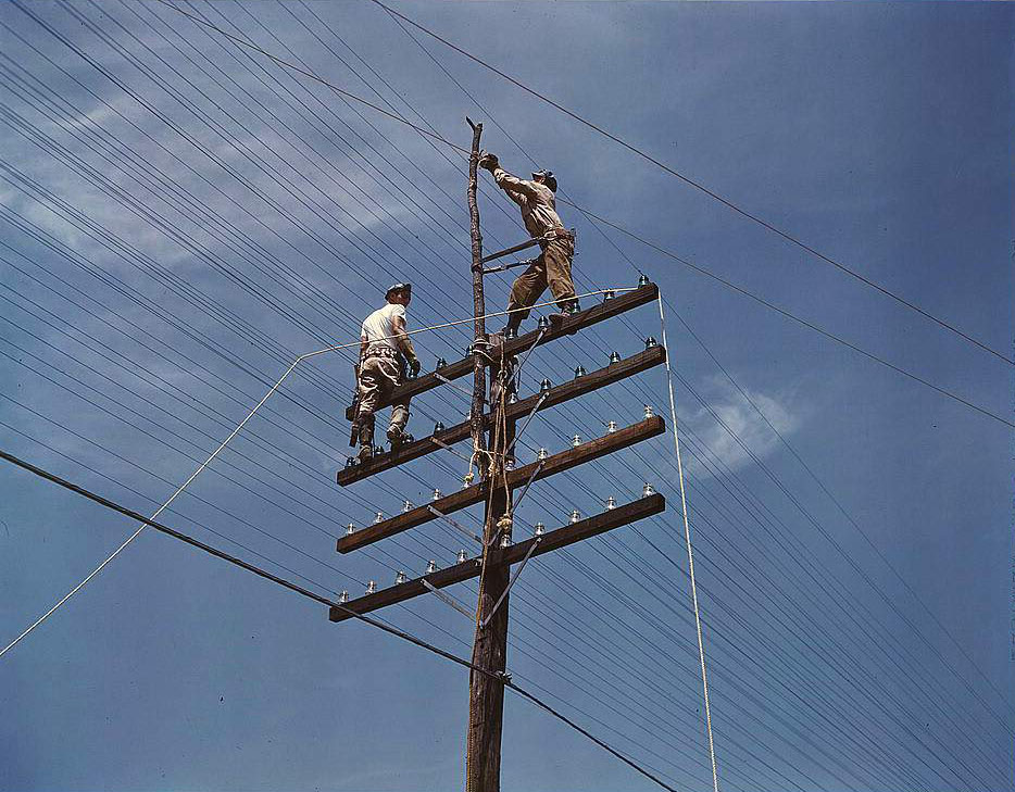 Men working on telephone lines, probably near a TVA dam hydroelectric plant, 1950s