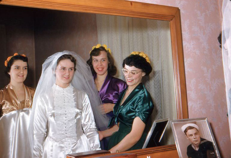 Bride and bridesmaids in mirror, USA, 1954