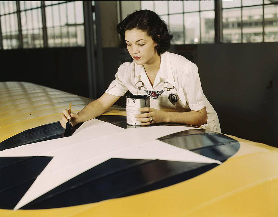 Painting the American insignia on airplane wings is a job that Mrs. Irma Lee McElroy, a former office worker, does with precision and patriotic zeal, 1950s