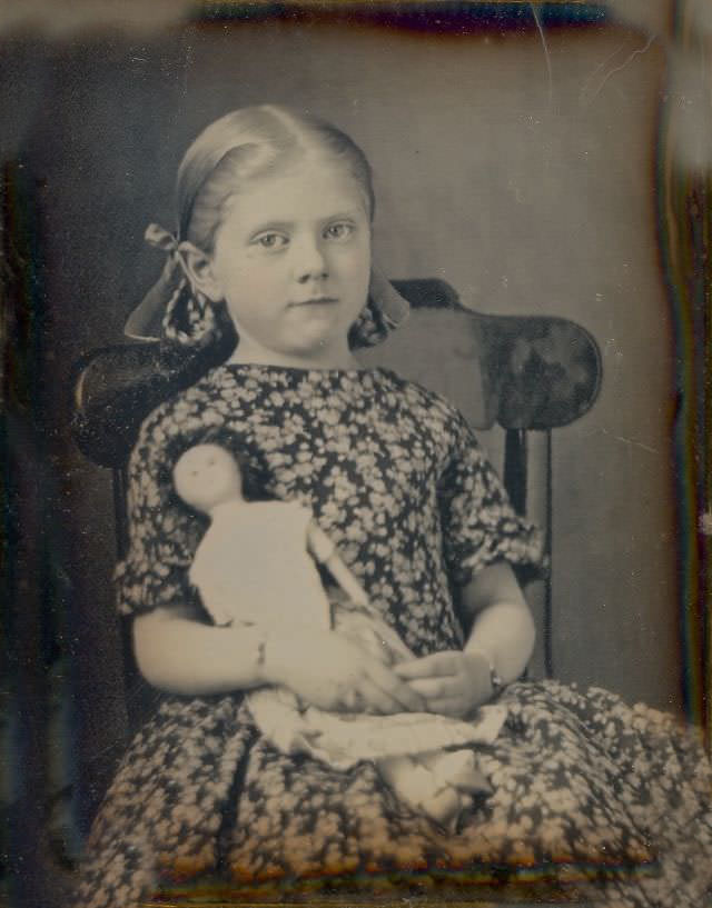 A sweet little girl holding her doll
