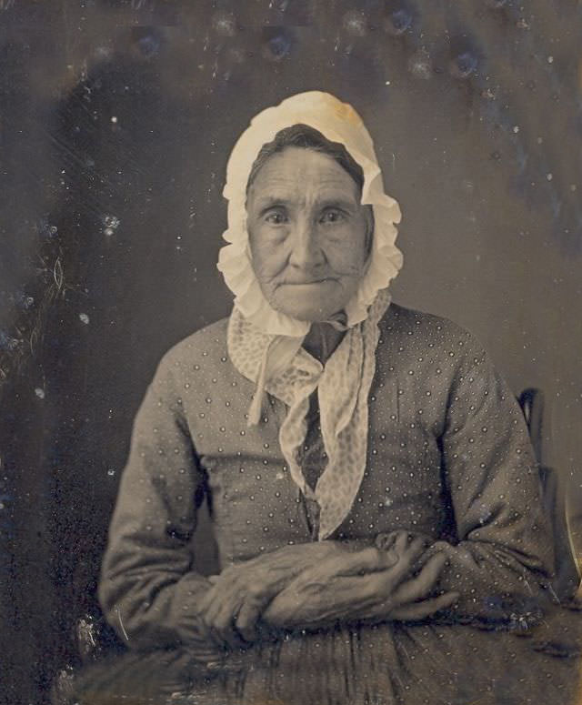 A sweet looking senior lady wearing a bonnet