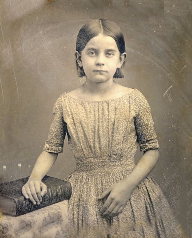 A young rural girl standing by a big book