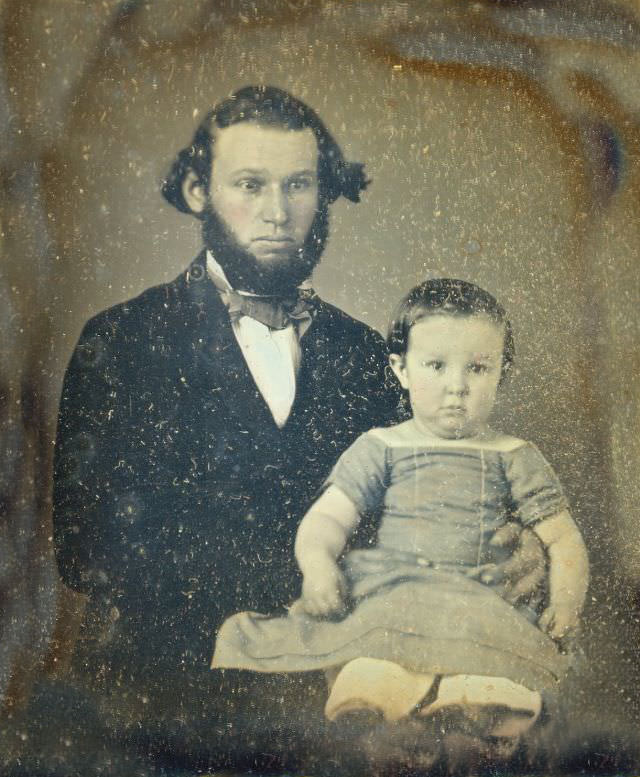 Reverend C T Douglas holding his son Travis on his lap