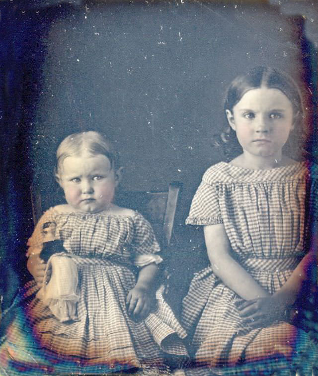 Sisters with doll