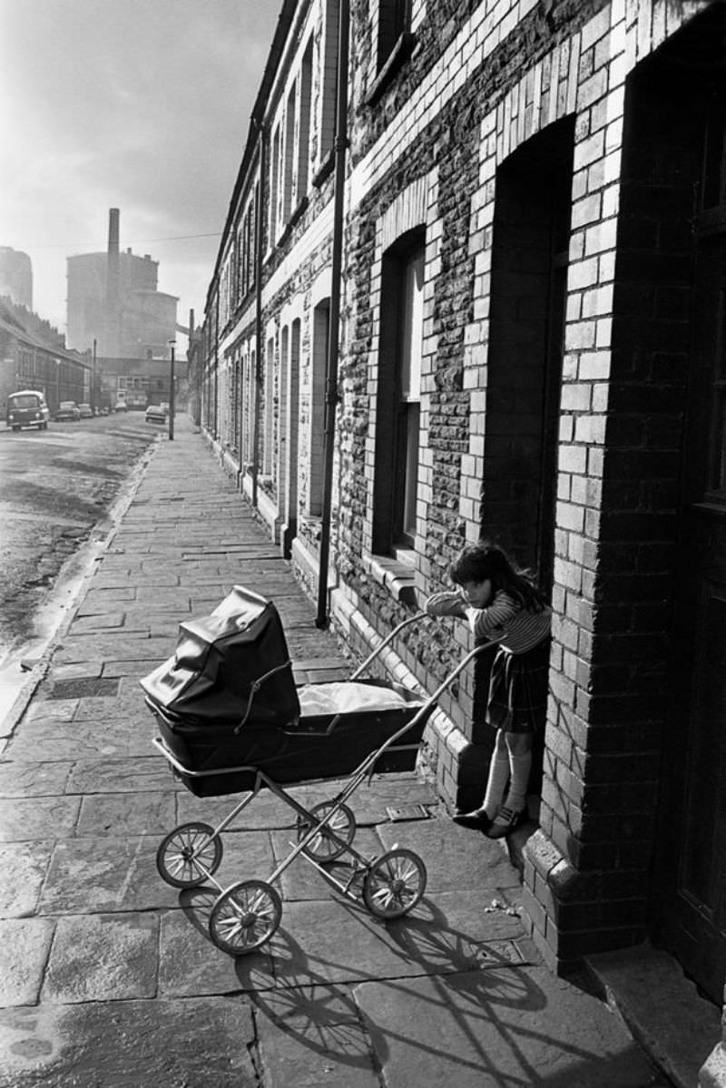 A girl plays with a baby in Splott, Cardiff