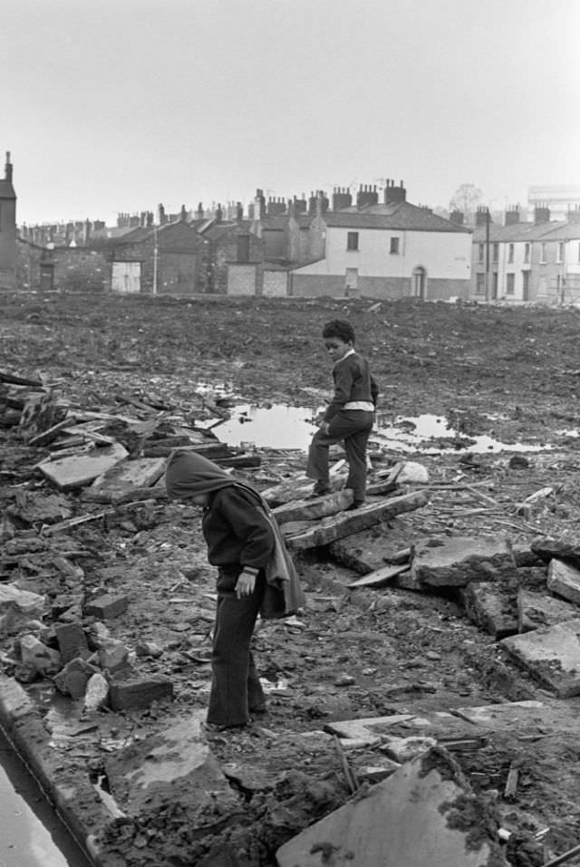 Children playing where old terraced houses have been demolished to make way for redevelopment, Pill, Newport