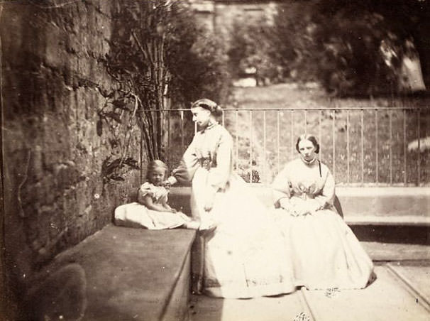Two women and a girl in a garden
