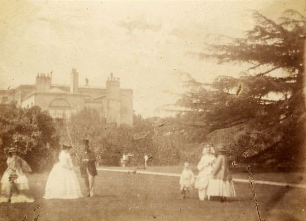 People in gardens of unidentified house