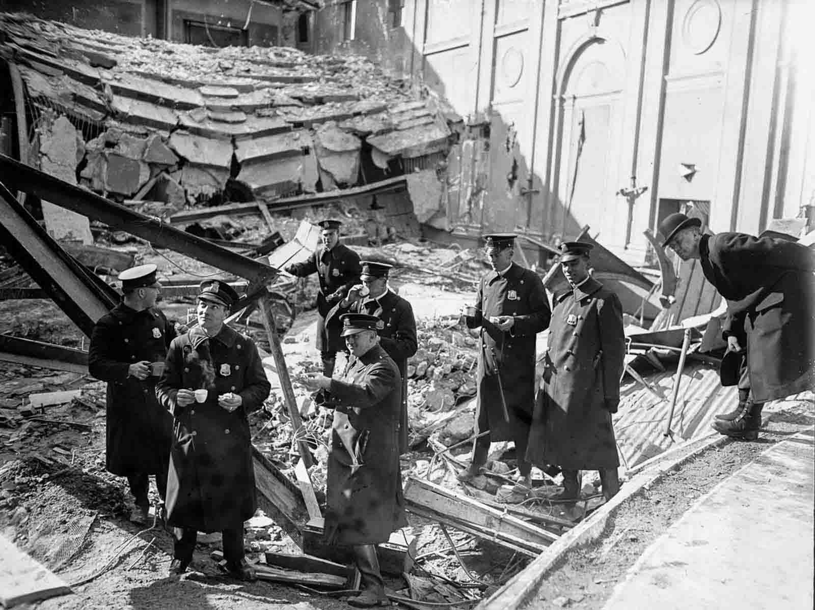 Police inspect the wreckage after the end of rescue efforts.