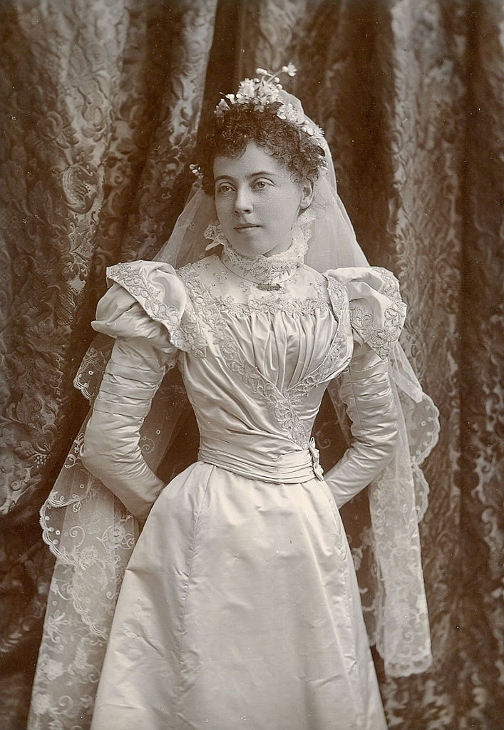 Young lady poses in her wedding dress, 1885