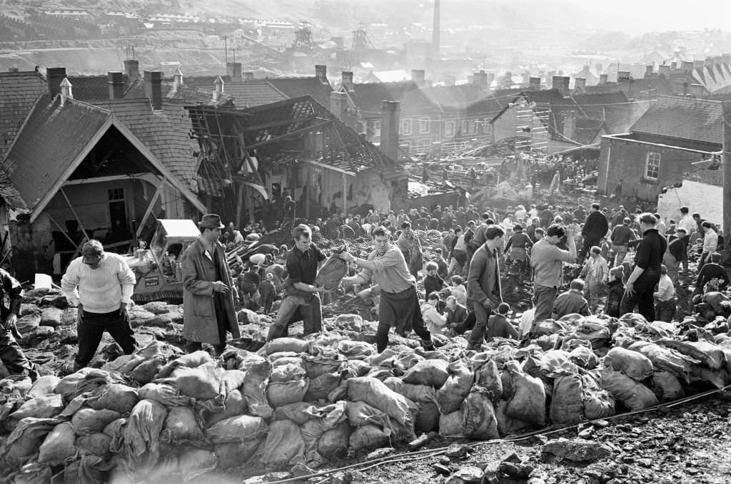 Rescue workers bagging and moving some of the coal spoil following the catastrophic collapse of a colliery spoil tip in the Welsh village of Aberfan, near Merthyr Tydfil, on 21 October 1966.