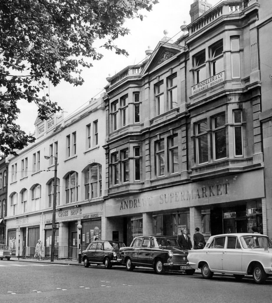 The unoccupied buildings of Cross Bros Ltd, and Andrews Supermarket in Working Street, Cardiff, South Glamorgan, Wales, 2nd August 1966.