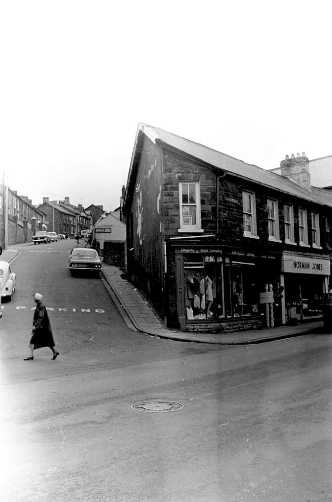 A woman crosses the street in the mining town of Tonypandy, Wales, United Kingdom, 1966.