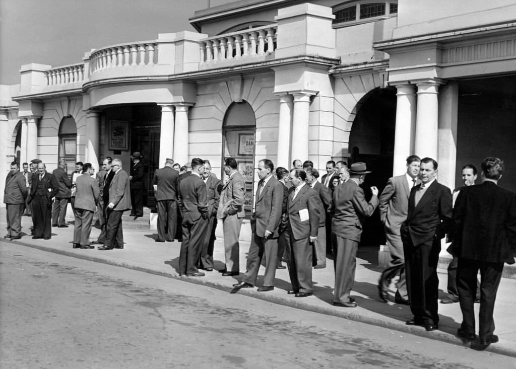Miners wait outside of the Pavilion at Porthcawl, for the annual NUM South Wales miners conference, Porthcawl, Bridgend, South Wales, 1st May 1962.