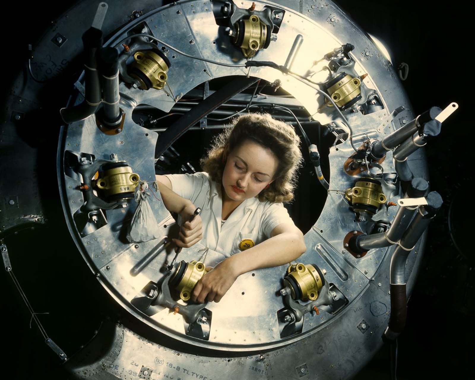 A worker assembles part of the cowling for a B-25 bomber motor at the North American Aviation plant in Inglewood, California, 1942.