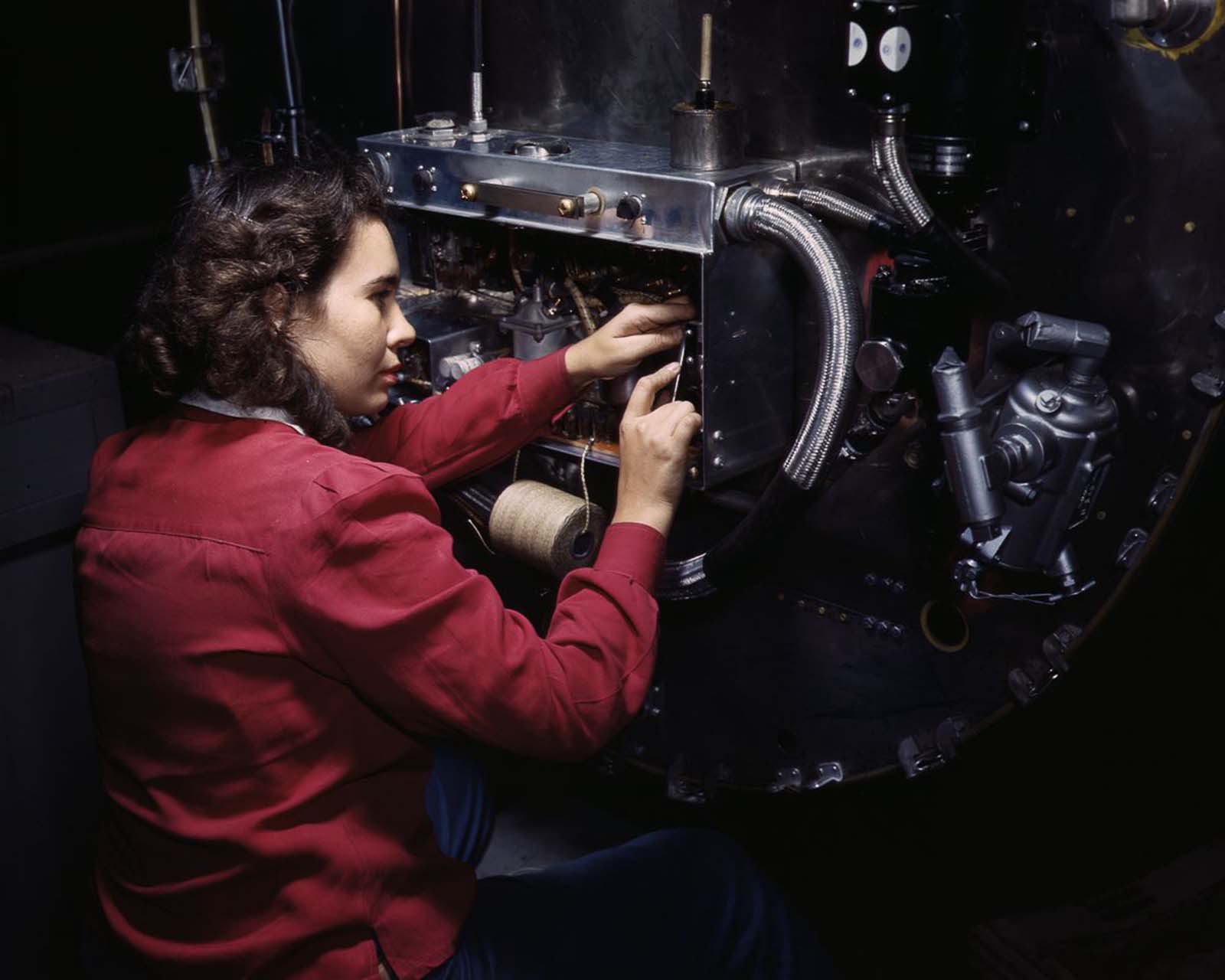 A worker assembles switch boxes on the firewall of a B-25 bomber at the North American Aviation plant in Inglewood, California, 1942.