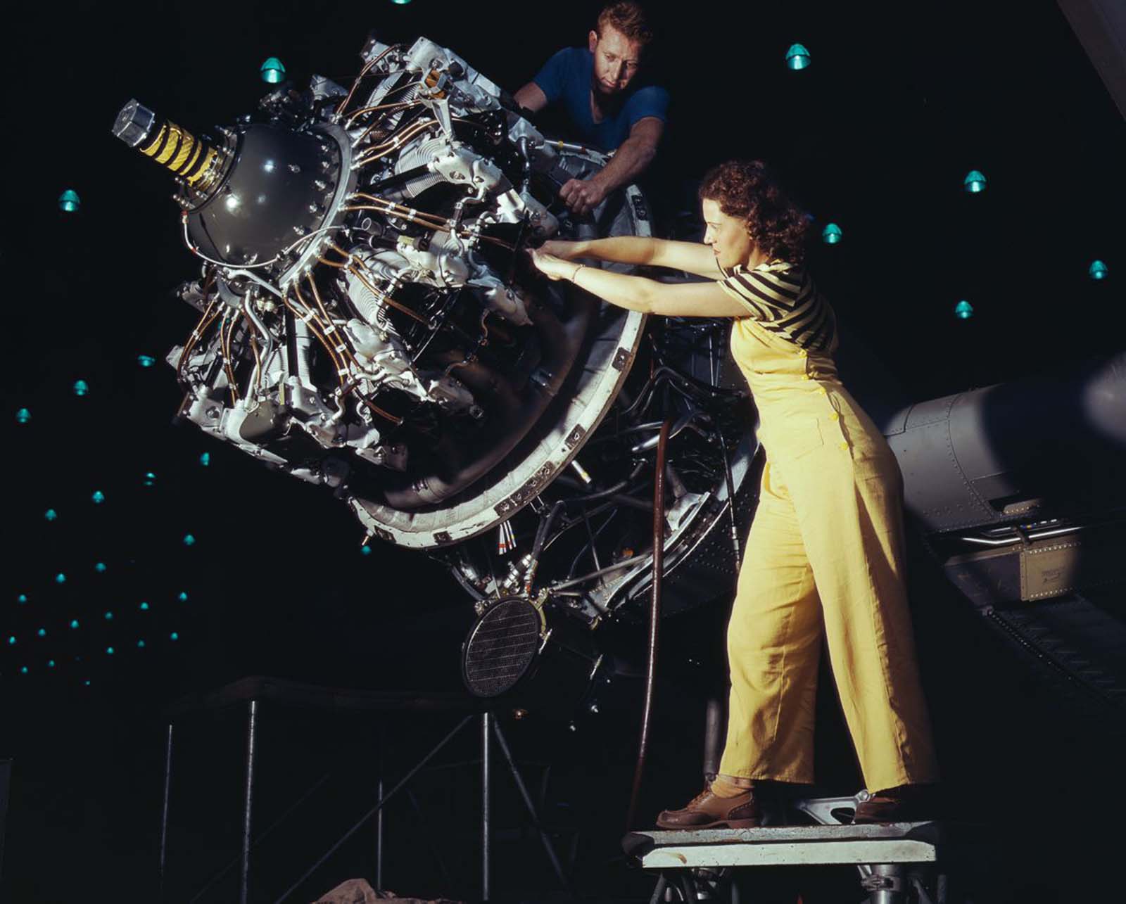 Douglas Aircraft Company employees work an airplane motor at the plant in Long Beach, California, 1942.