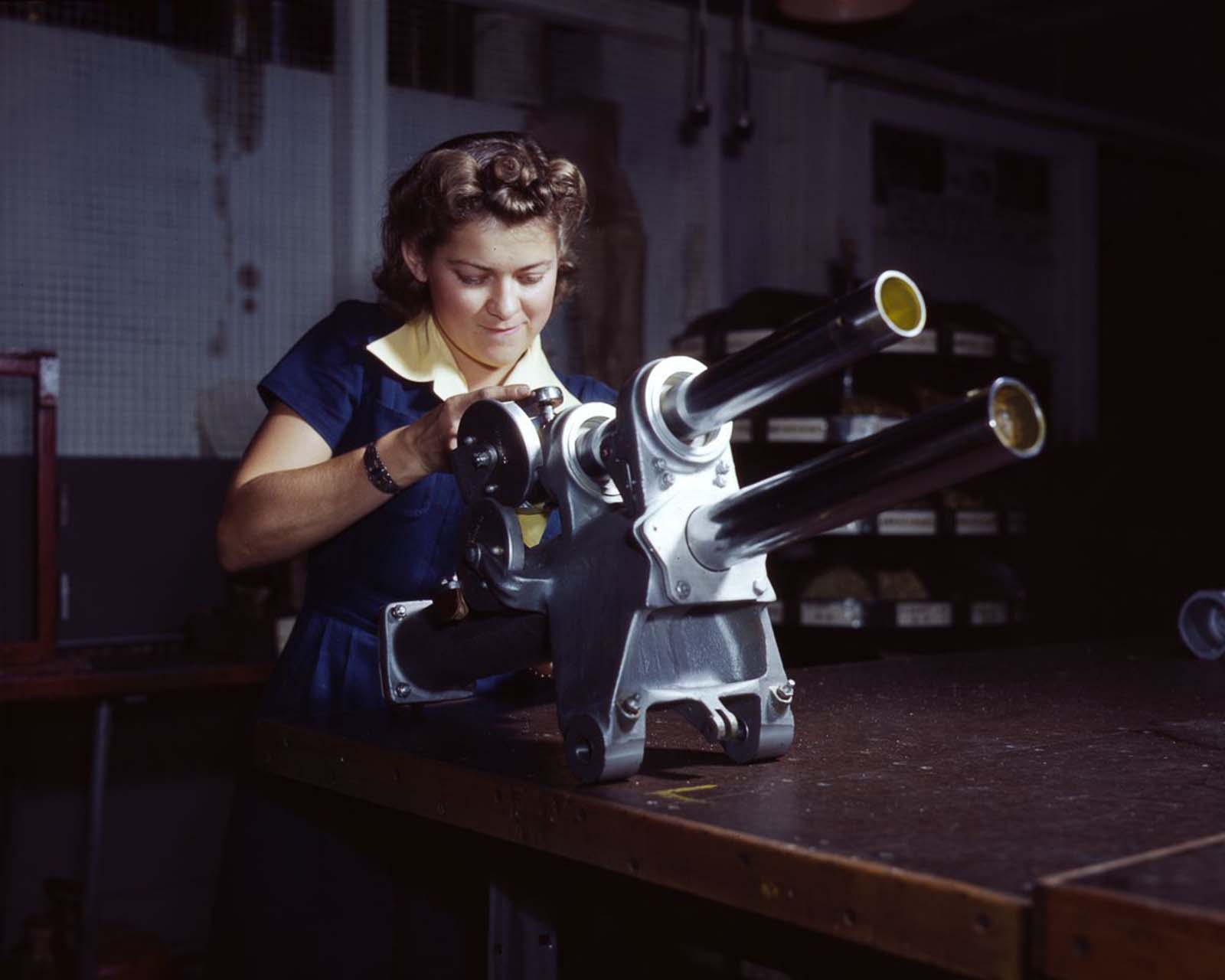 A North American Aviation employee works on the landing gear mechanism of a P-51 fighter at the plant in Inglewood, California, 1942.