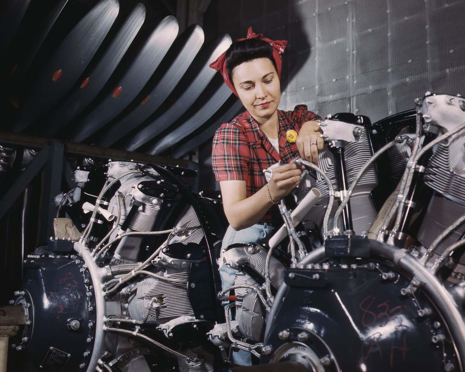 A worker adjusts an airplane motor at the North American Aviation plant in Inglewood, California, 1942.