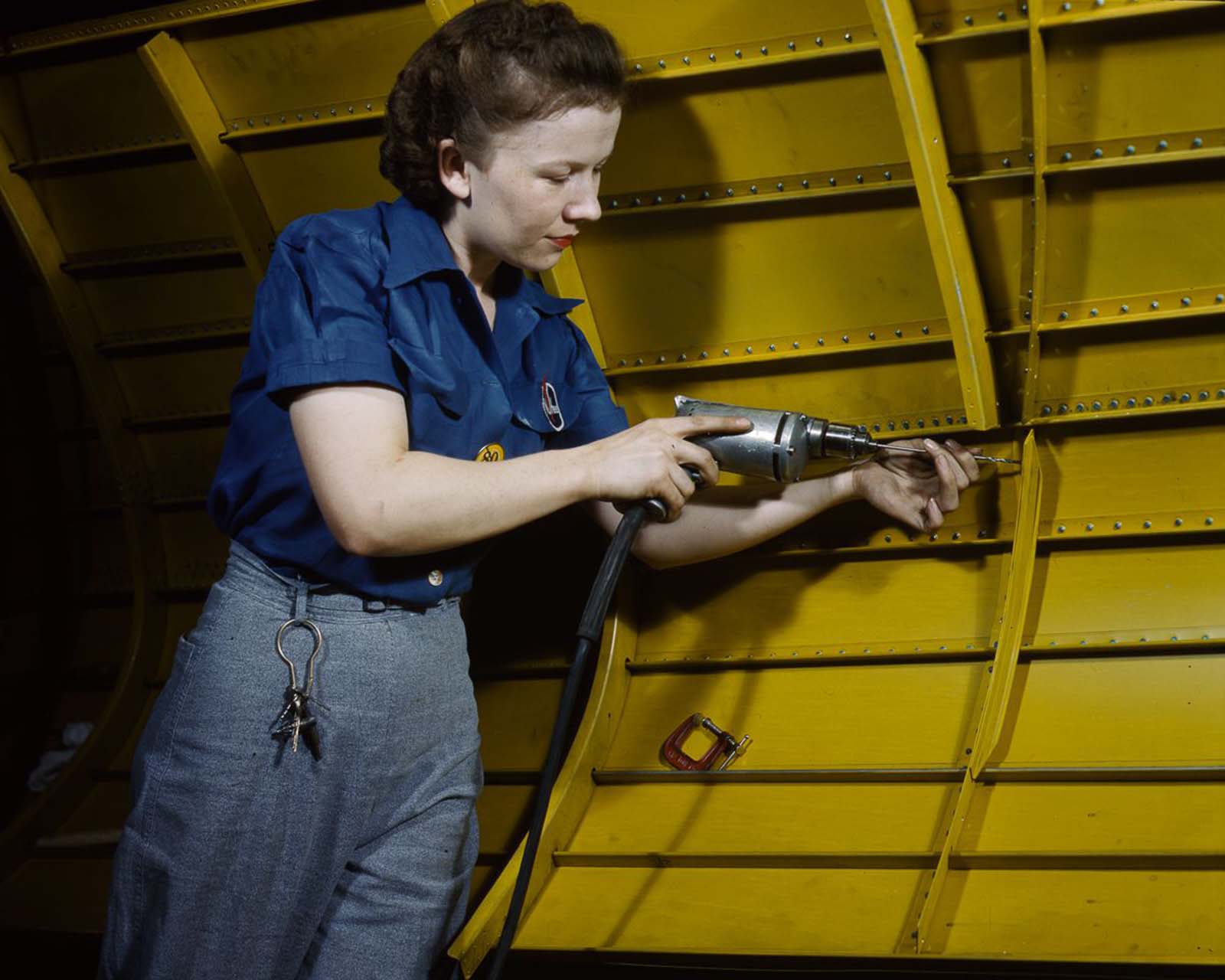 A worker uses a power drill on an A-31 “Vengeance” dive bomber at the Vultee factory in Nashville, Tennessee, 1943.