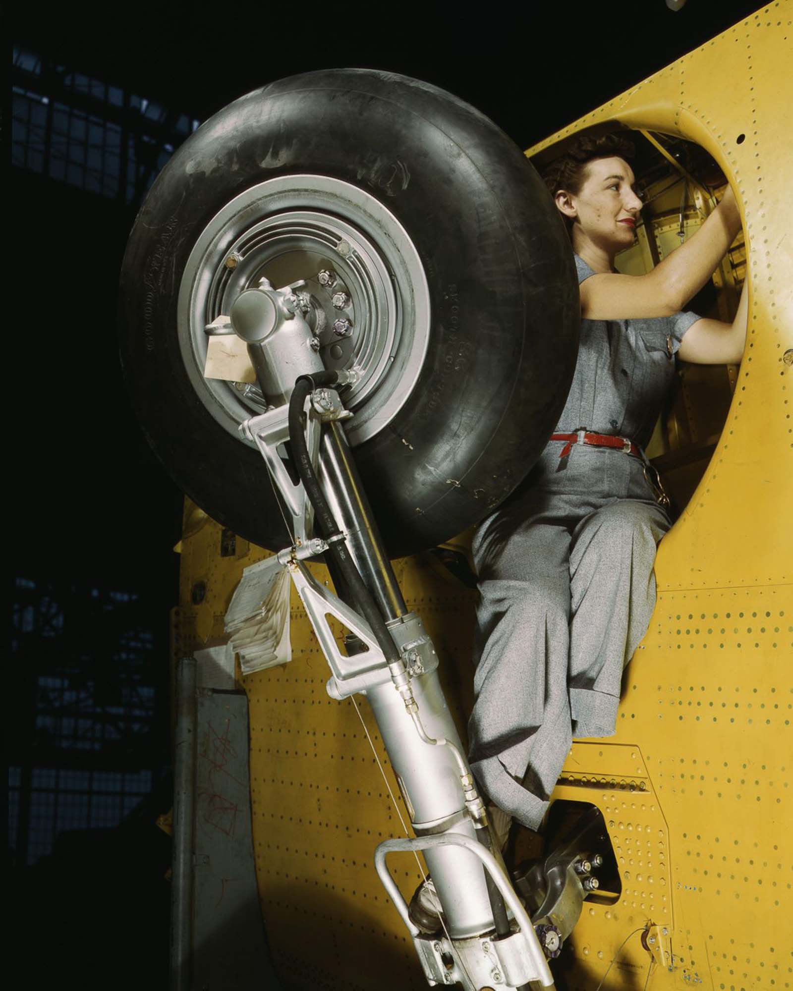 A Vultee Aircraft worker makes adjustments to the wheel well of a “Vengeance” dive bomber before installation of the landing gear at the plant in Nashville, Tennessee, 1943.