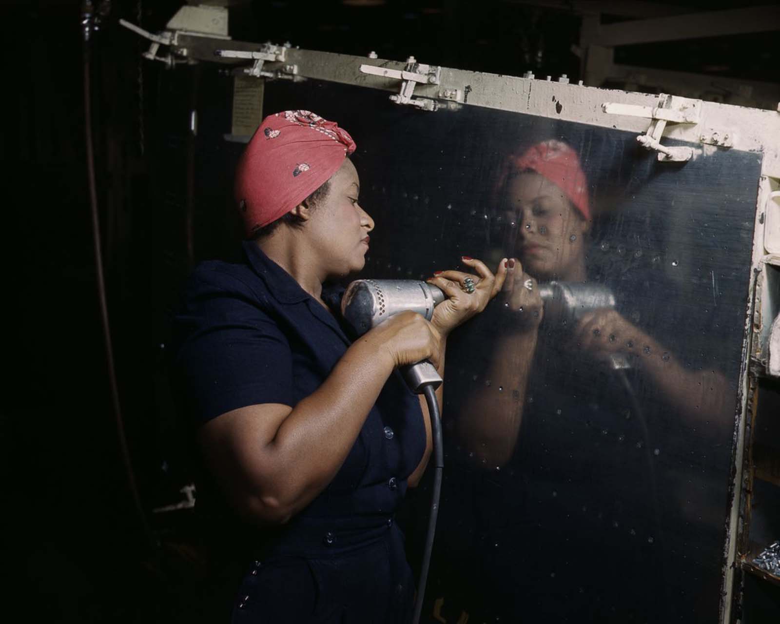 A worker drills rivets on an A-31 “Vengeance” dive bomber at the Vultee factory in Nashville, Tennessee, 1943.