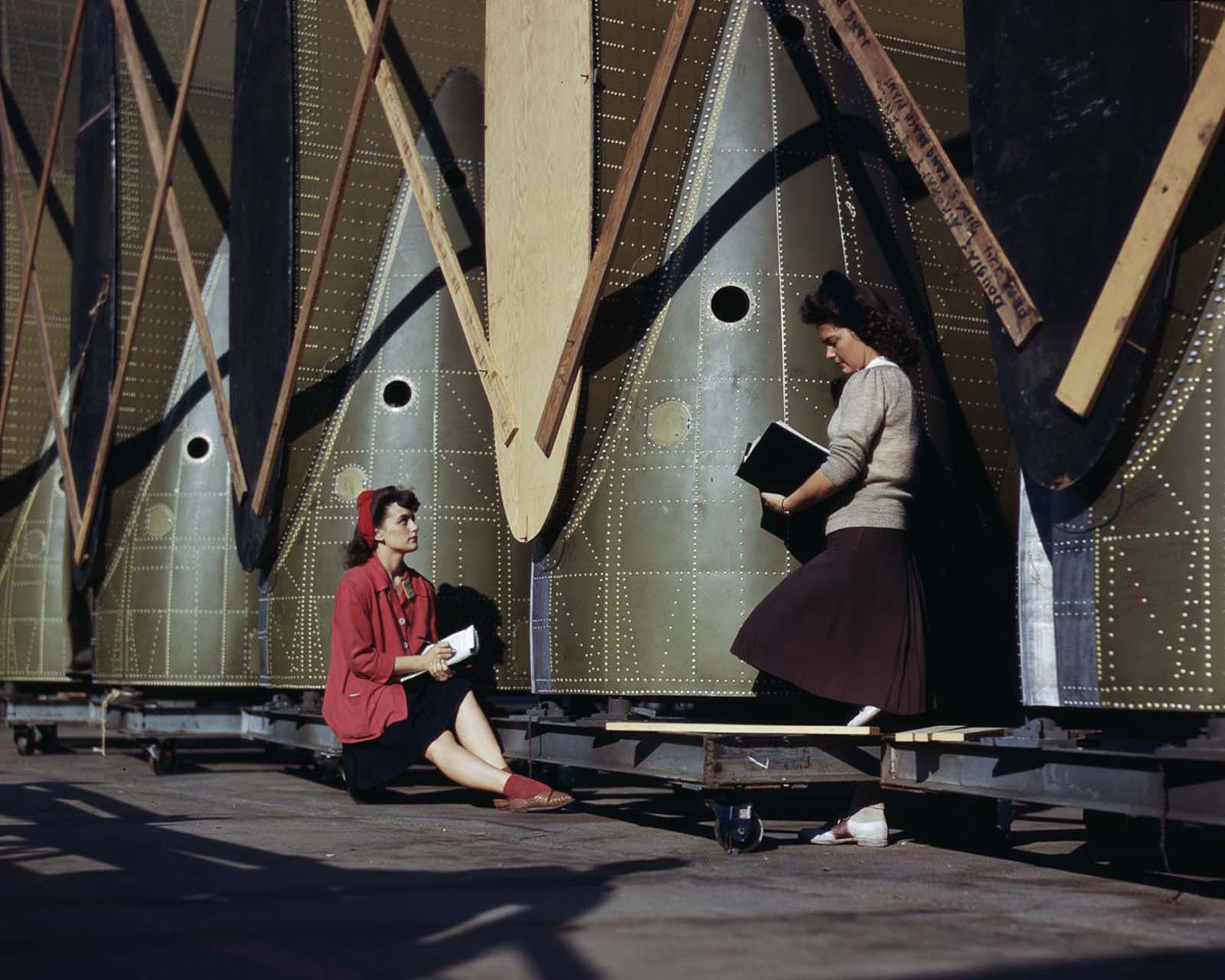 Inspectors examine wing parts of C-47 transport planes at the Douglas Aircraft Company plant in Long Beach, California, 1942.