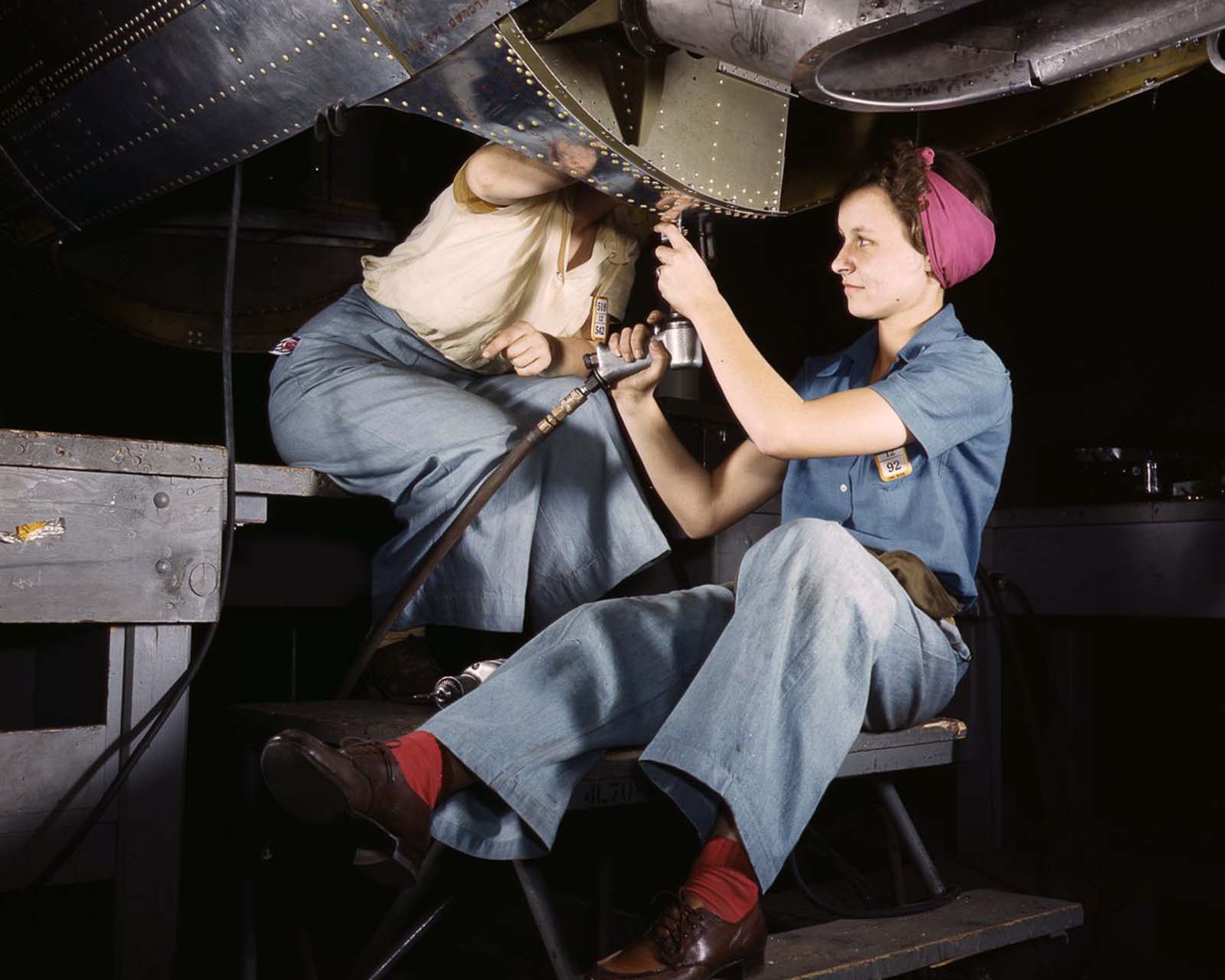 Douglas Aircraft Company employees work on the belly of a bomber at the plant in Long Beach, California, 1942.