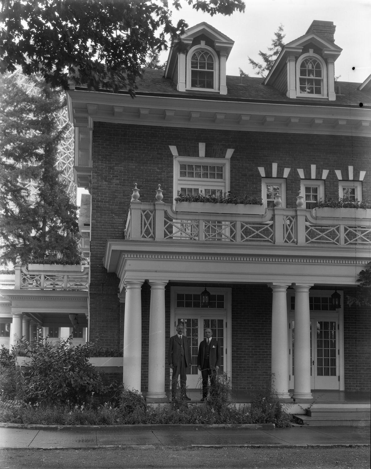 Governor Hartley and another man in front of the Governor's Mansion.