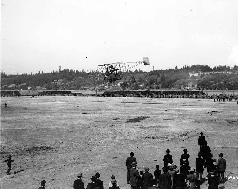 Fred J. Wiseman piloting the first airplane (biplane) to land at the first air show ("flyer") at Olympia, 1911.