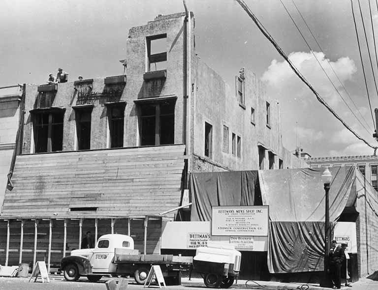 Steenson construction company truck parked in front of damaged Bettman's Men's Shop Inc, Olympia, April 1949