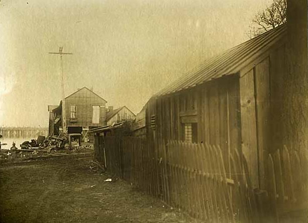 A building and a shed, identified as the rear of the Washington Standard building, in Olympia, 1890s