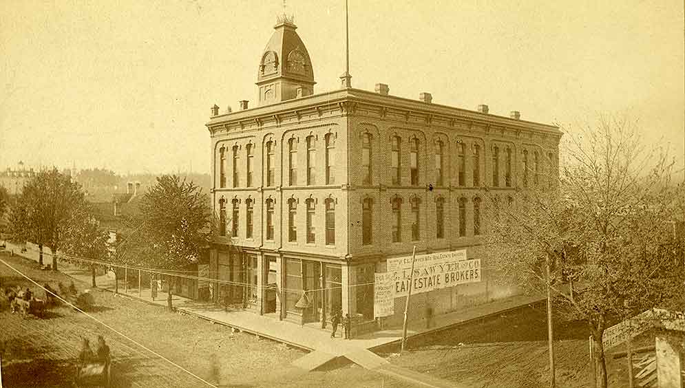 A three-story building with cupola identified as the Odd Fellows Hall, Olympia, 1899