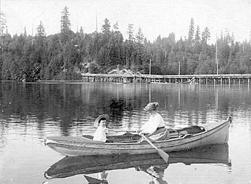 A woman and a child in a canoe on the Deschutes Estuary, Olympia, 1890s