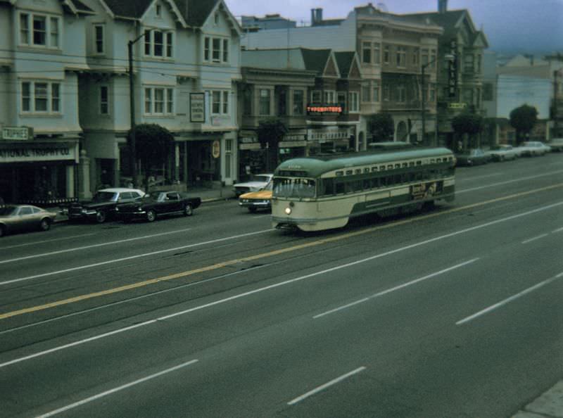 PCC heading downtown on Market Street between Noe Street/16th Street and Sanchez Street/15th Street on a foggy early evening, 1970