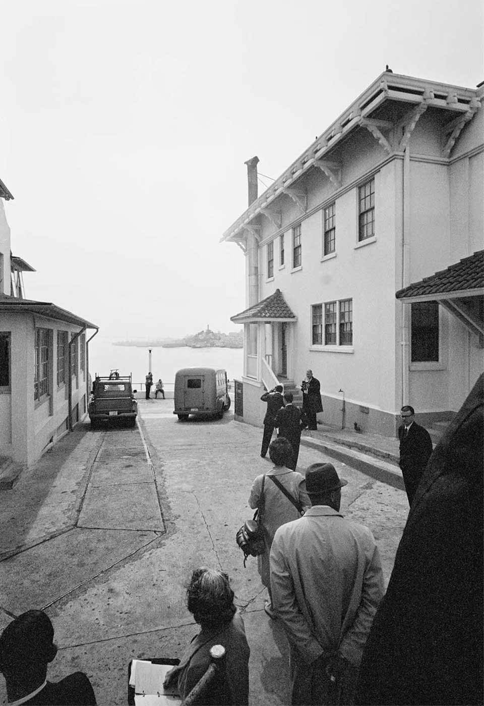 Convict’s Bus - The bus transporting convicts drives to the dock. On the left is the Warden’s House; on the right is the Lighthouse Keepers’ Quarters.