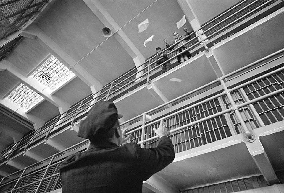 Guard - An officer plays with kids on C-D Street in the empty prison.