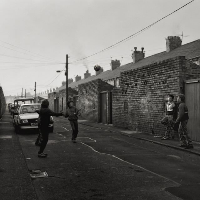 Boys playing football on Beatrice Street, 1979