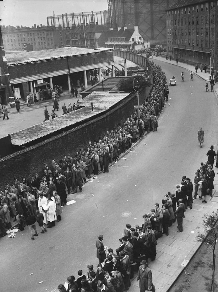 A crowd of cricket spectators queuing outside the Kennington Oval, London, 1948